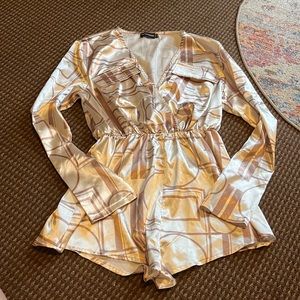 Cream romper with drown pattern.